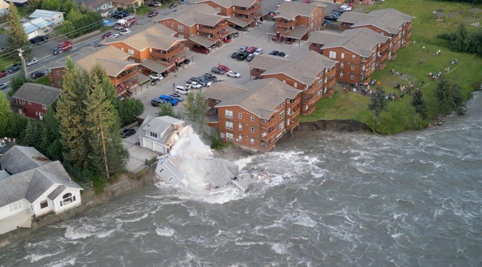 A drone view shows the house collapsing into the river due to glacial floods in Juneau on Aug. 5, 2023. @twowildhearts via REUTERS