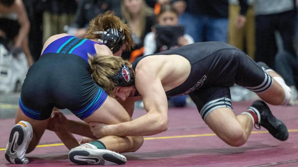 Nampa’s Carson Exferd, right, competes with Century’s Kolter Burton, left, in the 138-pound championship at the Rollie Lane Invitational on Jan. 6 at the Ford Idaho Center in Nampa.