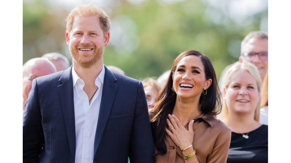 Prince Harry and Meghan Markle smiling in Dusseldorf