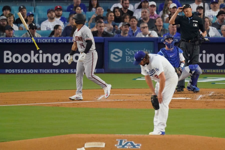 Arizona Diamondbacks’ Gabriel Moreno, left, tosses his bat after hitting a three-run home run as Los Angeles Dodgers starting pitcher Clayton Kershaw looks on during the first inning in Game 1 of a baseball NL Division Series Saturday, Oct. 7, 2023, in Los Angeles. (AP Photo/Mark J. Terrill)