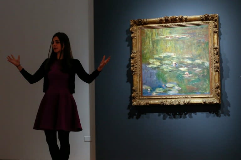An art expert at Christie's speaks about the artwork 'Le bassin aux nympheas' by Claude Monet, during a press preview ahead of spring auctions in New York, on April 29, 2016