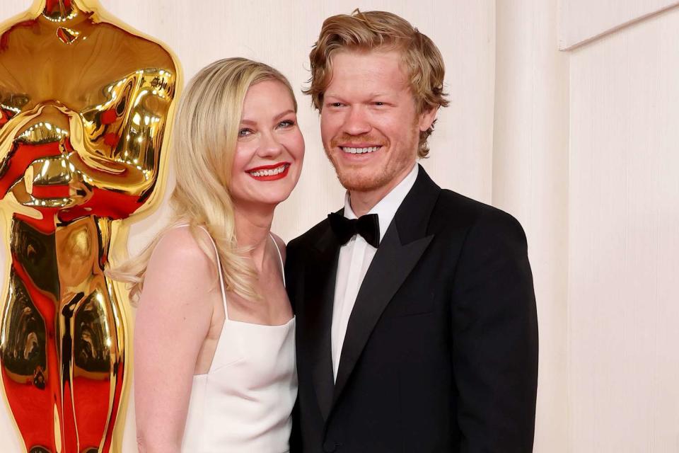 <p>Mike Coppola/Getty</p> Kirsten Dunst and Jesse Plemons at the 96th Academy Awards in Los Angeles