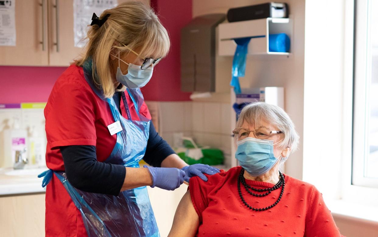 A patient receives their first dose of the Oxford/AstraZeneca coronavirus vaccine at a GP surgery in Horsham, West Sussex, on Saturday -  Christopher Pledger