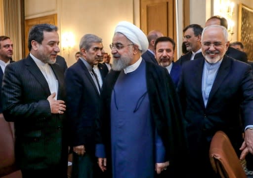 Iran's President Hassan Rouhani (C) warns his country could shut down the strategic Strait of Hormuz