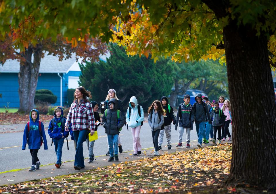 Fairfield Elementary School principal Jenny Sink leads a group of students for Ruby Bridges Walk to School Day from Petersen Barn Community Center on Monday, Nov. 14, 2022.