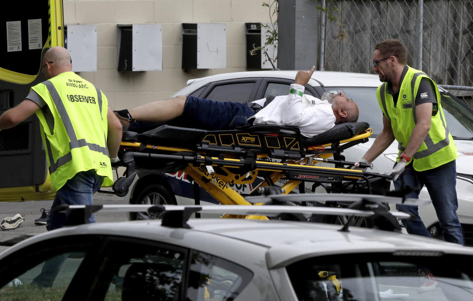 FILE - In this March 15, 2019, file photo, ambulance staff take a man from outside a mosque in central Christchurch, New Zealand. Tentative plans for a movie that recounts the response of New Zealand Prime Minister Jacinda Ardern to a gunman's slaughter of Muslim worshippers drew criticism in New Zealand on Friday, June 11, 2021 for not focusing on the victims of the attacks. (AP Photo/Mark Baker, File)