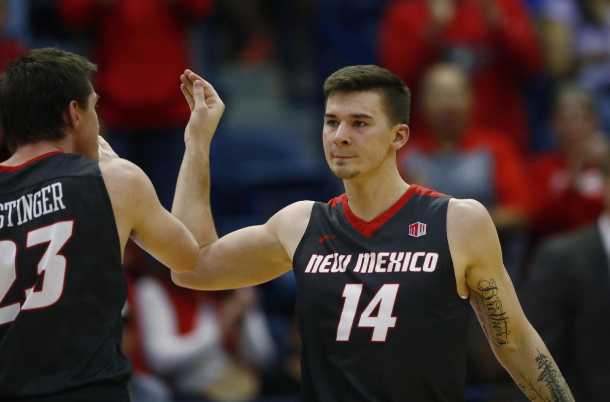 New Mexico forward Joe Furstinger, left, celebrates with guard Dane Kuiper late in the second half of an NCAA college basketball game against Air Force late, Wednesday, Feb. 8, 2017, at Air Force Academy, Colo. New Mexico won 74-67. (AP Photo/David Zalubowski)