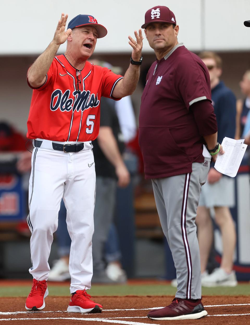 Ole Miss Rebels Head Coach Mike Bianco interacts with Mississippi State Bulldogs Head Coach Chris Lemonis before their game at Oxford-University Stadium on Thursday, April 21, 2022. 