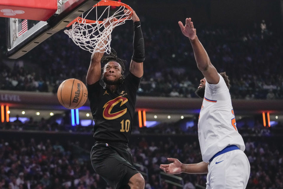 Cleveland Cavaliers guard Darius Garland (10) dunks past New York Knicks center Mitchell Robinson in the first half of Game 4 in an NBA basketball first-round playoff series, Sunday, April 23, 2023, at Madison Square Garden in New York. (AP Photo/Mary Altaffer)