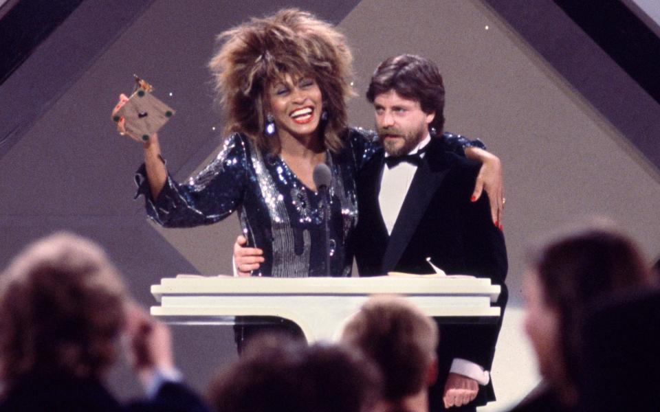 Tina Turner at the 1985 Grammys with Terry Britten, the co-writer of What's Love Got To Do With It - CBS