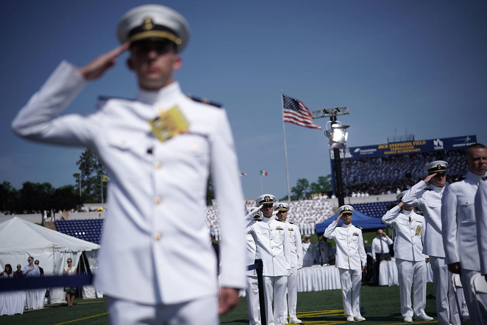 <p>Members of the U.S. Navy salute as they listen to the national anthem during a graduation ceremony at the Navy-Marine Corps Memorial Stadium of the U.S. Naval Academy May 25, 2018 in Annapolis, Md. (Photo: Alex Wong/Getty Images) </p>