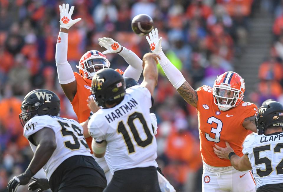 Clemson defensive end Myles Murphy (98) and  defensive end Xavier Thomas (3) pressure Wake Forest quarterback Sam Hartman (10) during the third quarter at Memorial Stadium in Clemson, South Carolina Saturday, November 20, 2021.