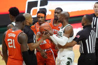 Referees separate Illinois guard Trent Frazier, center, and Michigan State guard Joshua Langford during the second half of an NCAA college basketball game, Tuesday, Feb. 23, 2021, in East Lansing, Mich. (AP Photo/Carlos Osorio)