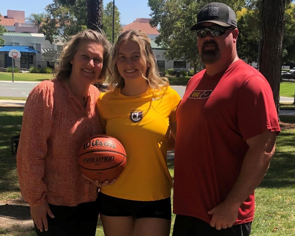 Haley Madsen (center) poses for a photo with her mom Shannon and father Dave.