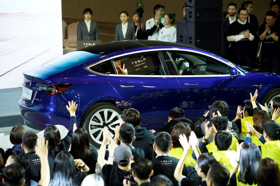 A Tesla China-made Model 3 vehicle owner sits inside a car during a delivery event at Tesla's Shanghai factory in China January 7, 2020. REUTERS/Aly Song