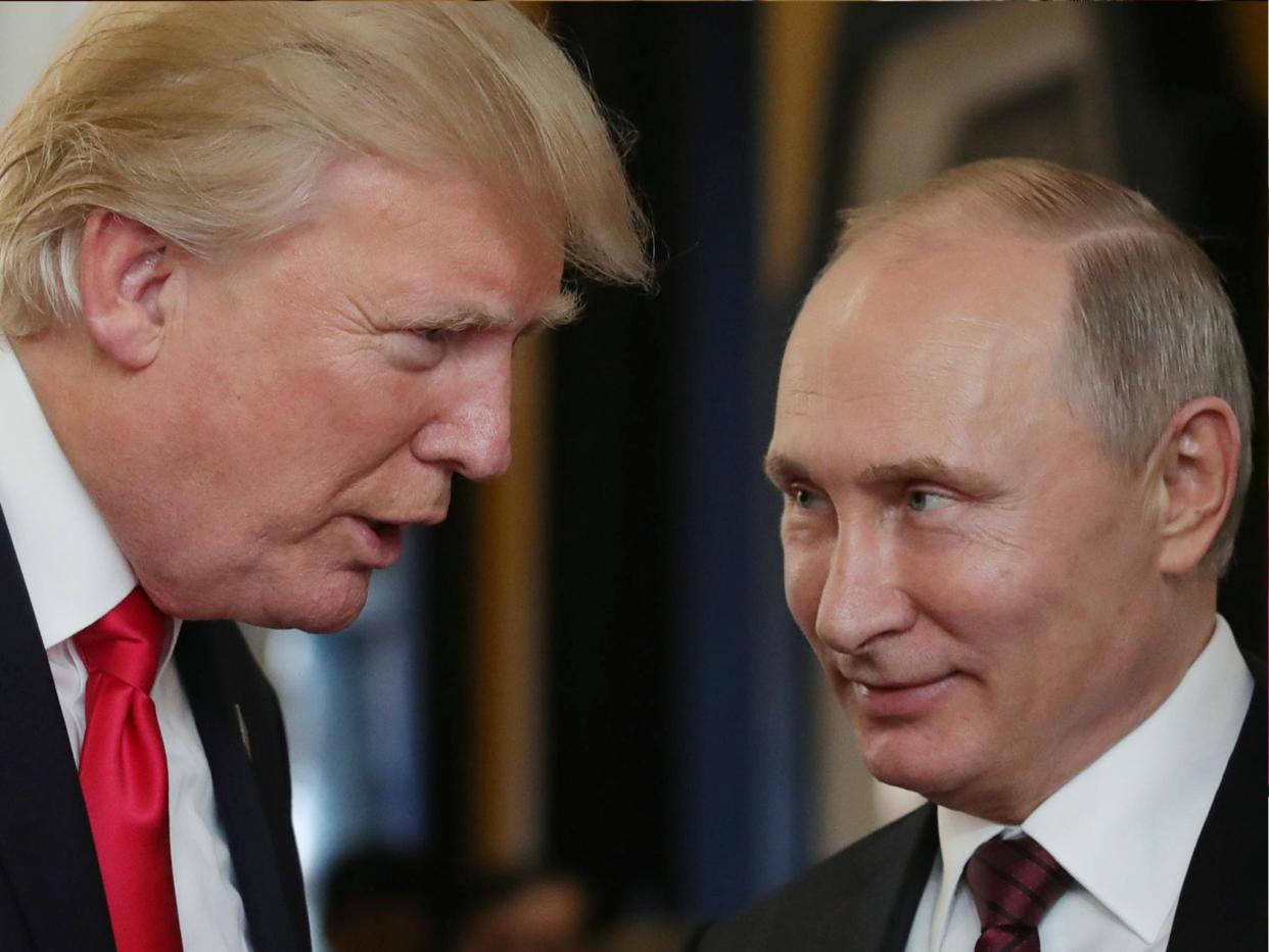 US President Donald Trump chats with Russia's President Vladimir Putin in Danang, Vietnam on 11 November 2017: MIKHAIL KLIMENTYEV/AFP/Getty Images