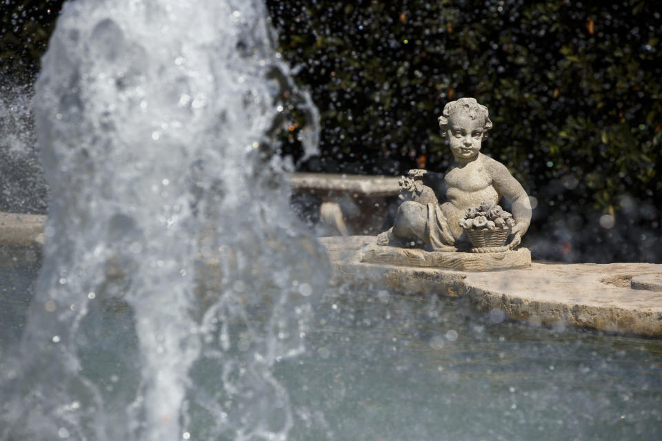 A sculpture&nbsp;gazes at&nbsp;a&nbsp;fountain in front of the sisters' former home.