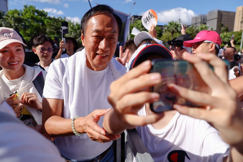 Supporters take a selfie with Terry Gou, the retired founder of major Apple supplier Foxconn in Taipei