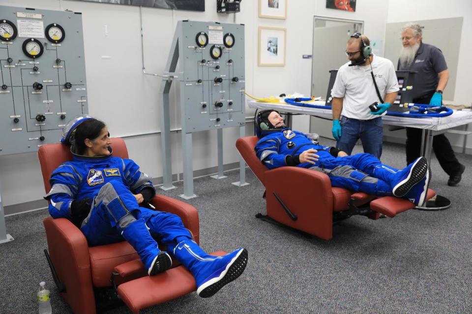 From left, NASA astronauts Suni Williams and Barry “Butch” Wilmore, Boeing Crew Flight Test (CFT) pilot and commander, respectively, check their spacesuits during a crew validation test inside the Astronaut Crew Quarters at NASA’s Kennedy Space Center in Florida in October 2022.