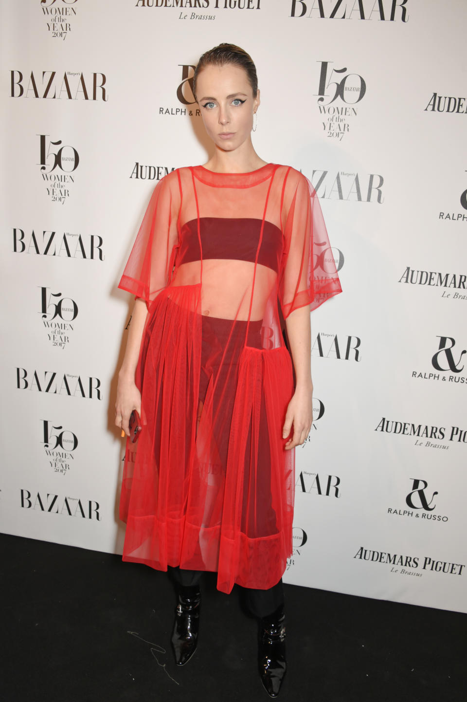 <p>The model opted for a sheer red Molly Goddard dress worn over a black bandeau and trousers.<br><i>[Photo: Getty]</i> </p>