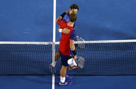 Spain's David Ferrer (top) speaks with Australia's Lleyton Hewitt after Ferrer won their second round match at the Australian Open tennis tournament at Melbourne Park, Australia, January 21, 2016. REUTERS/Jason O'Brien