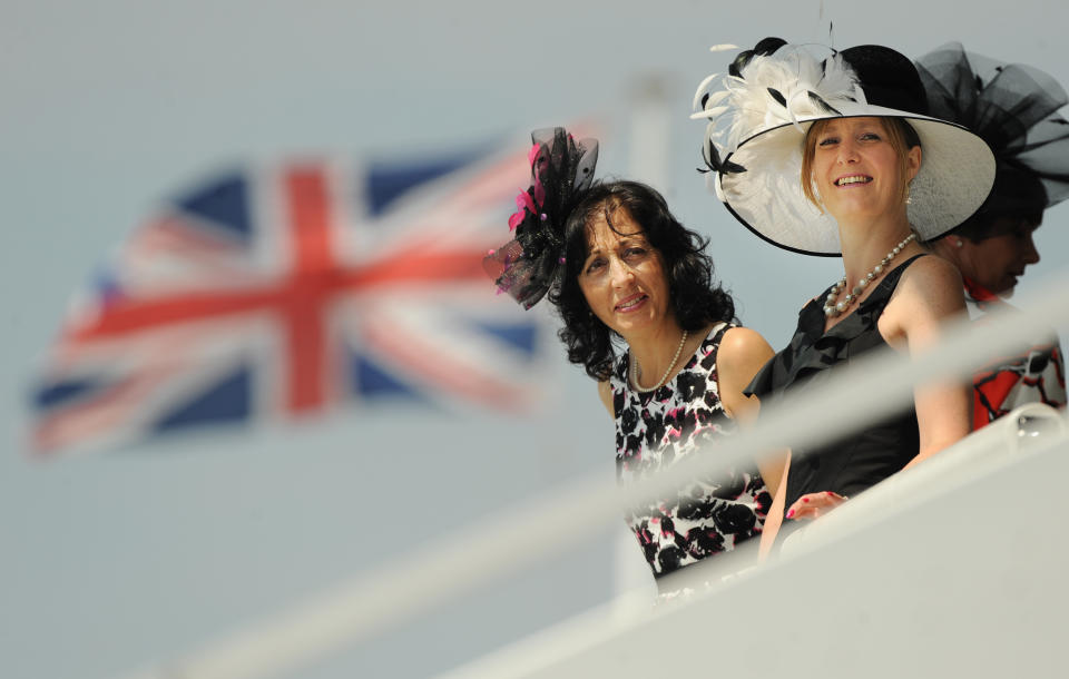 Racegoers gather for Derby Day, the second day of the Epsom Derby, in Surrey, southern England on June 4, 2011. The Queen's horse, Carlton House, ridden by Ryan Moore, is seeking to be the first Derby winner owned by a reigning monarch since Minoru won in 1909 for King Edward VII. AFP PHOTO/ BEN STANSALL (Photo credit should read BEN STANSALL/AFP/Getty Images)