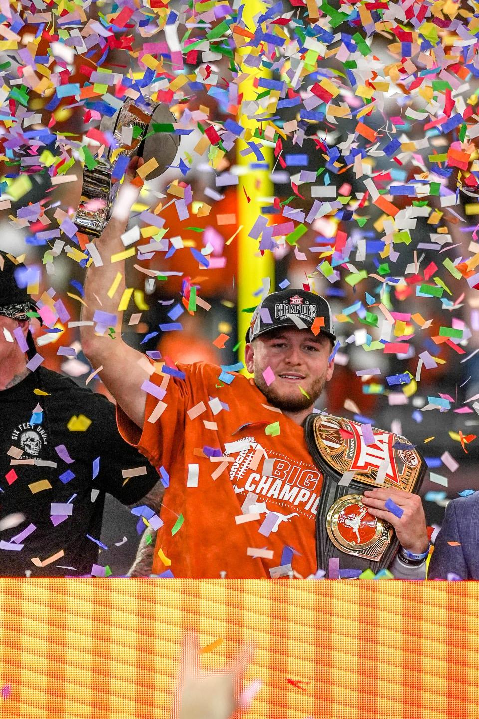 Texas quarterback Quinn Ewers holds up the Big 12 Championship Trophy after leading the Longhorns to a 49-21 win over Oklahoma State at AT&T Stadium on Dec. 2. Ewers guided Texas into the CFP field.