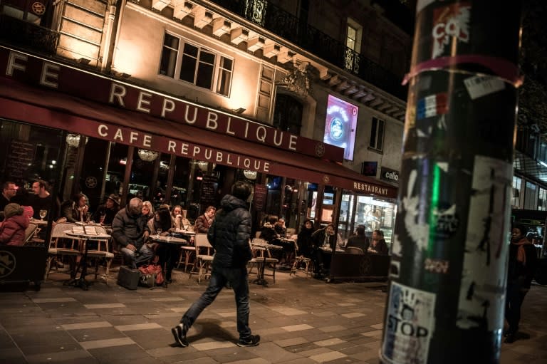 People sit on the terrace of the Cafe Republique near the Place de la Republique in Paris