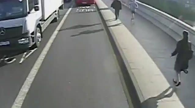 The woman can be seen in the bottom right approaching the jogger on the West London bridge. Picture: Metropolitan Police via AP