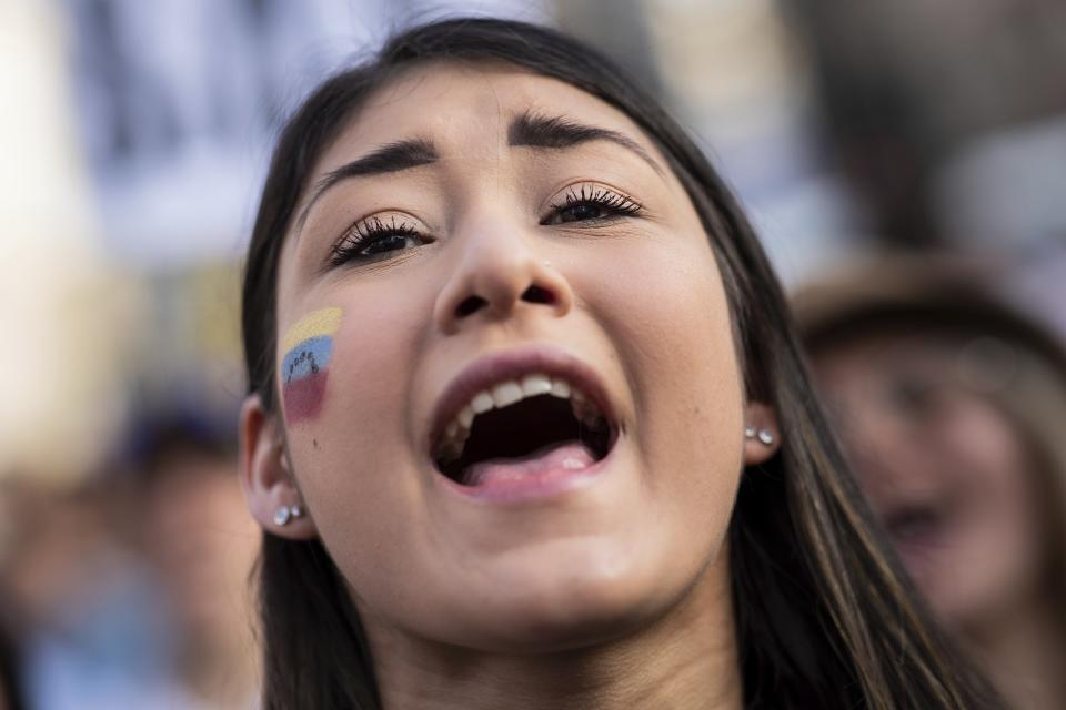 A Venezuelan woman shouts slogans in favor of Venezuelan opposition leader Juan Guaido in Madrid, Spain, Tuesday, April 30, 2019. Thousands of Venezuelans have migrated to Spain in recent years or are seeking asylum in the country, including prominent members of the opposition and former officials who worked closely with late Venezuelan President Hugo Chavez. More than 177,000 Spaniards live in Venezuela. (AP Photo/Bernat Armangue)