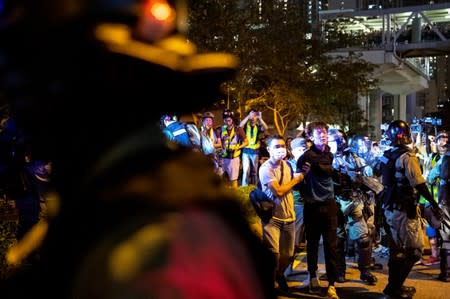 An anti-government protester is detained by police during a protest at Tseung Kwan O district, in Hong Kong