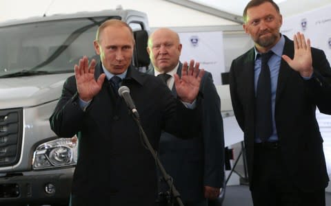  Russian President Vladimir Putin (L), Nizhny Novgorod region Governor Valeriy Shantsev (C) and billionaire Oleg Deripaska (R) examine a new Gazon Next vehicle - Credit: Getty Images Europe