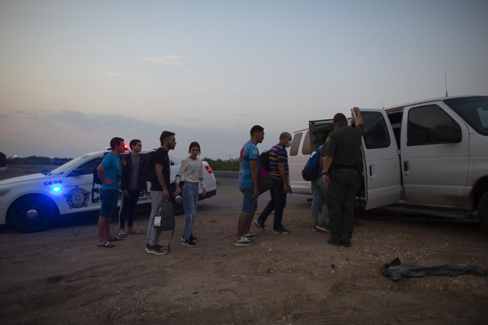 Migrants who had crossed the Rio Grande river into the United States are taken away by Border Patrol agents in Eagle Pass, Texas, Saturday, May 21, 2022. The Eagle Pass area has become increasingly a popular crossing corridor for migrants, especially those from outside Mexico and Central America, under Title 42 authority, which expels migrants without a chance to seek asylum on grounds of preventing the spread of COVID-19. (AP Photo/Dario Lopez-Mills)