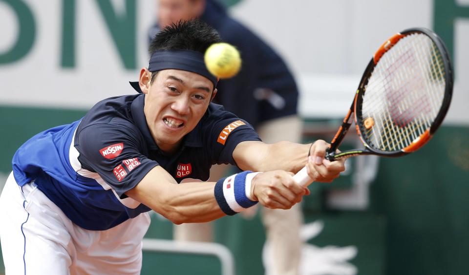 Kei Nishikori of Japan plays a shot to Teymuraz Gabashvili of Russia during their men's singles match at the French Open tennis tournament at the Roland Garros stadium in Paris