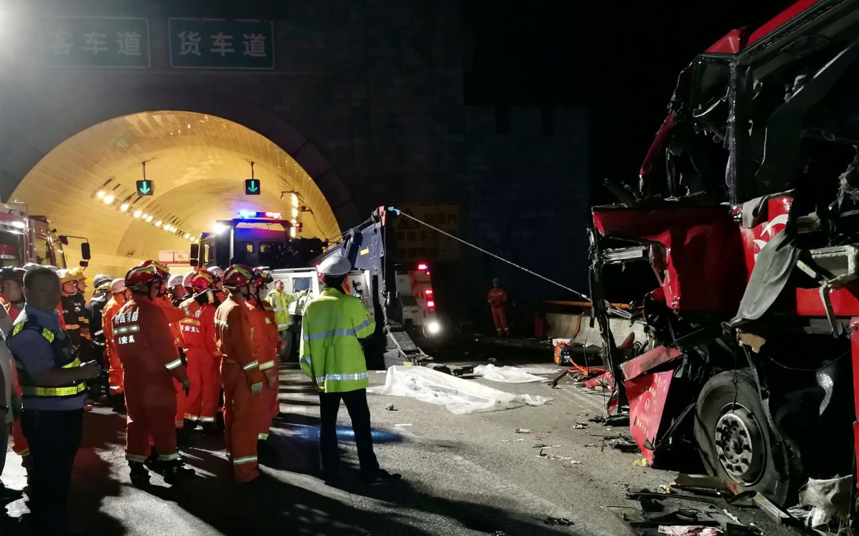 First responders work at the site of an accident after a coach hit the wall of the Qinling Mountains No. 1 Tunnel on the Jingkun Expressway  - Xinhua