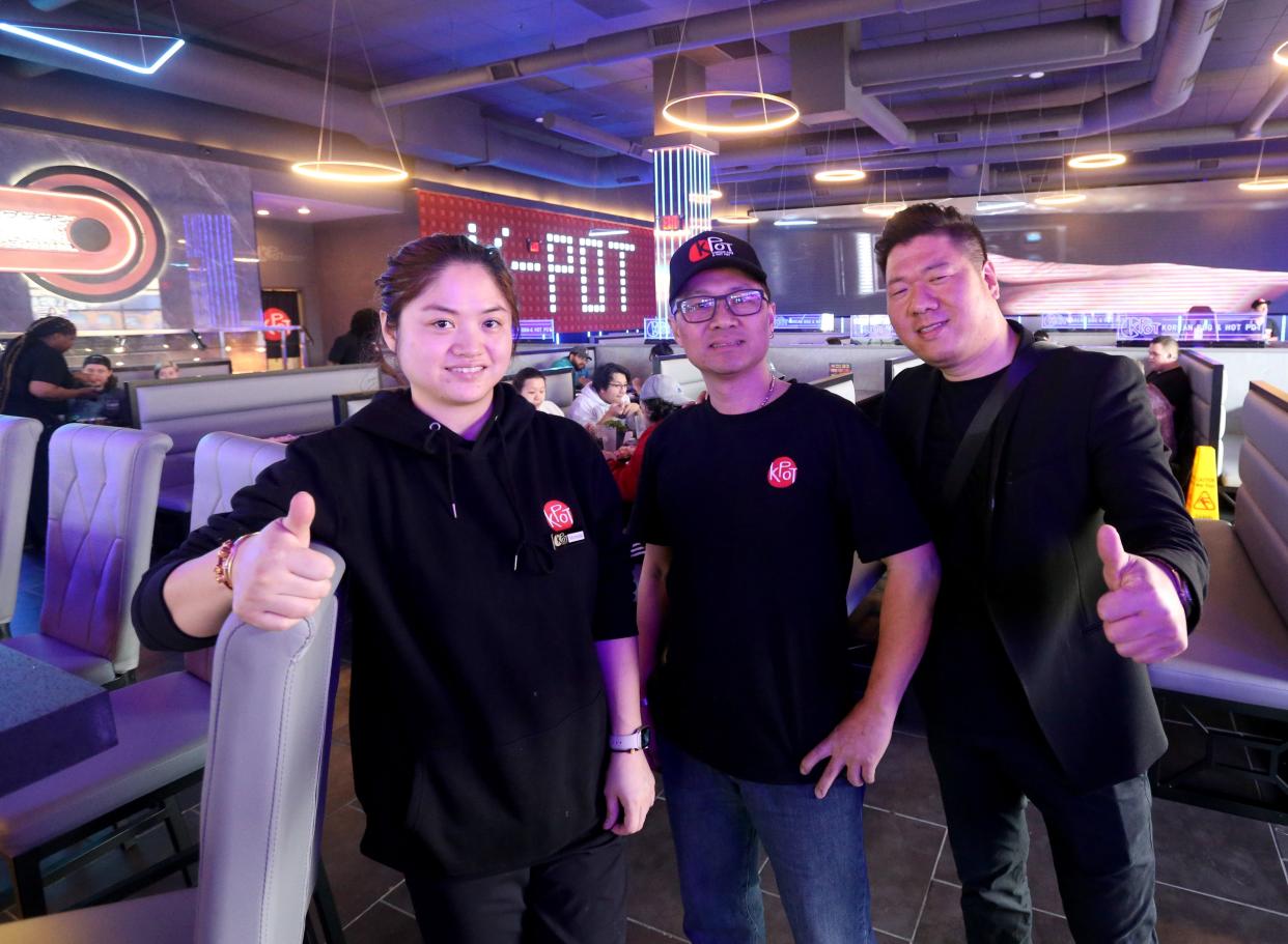 Co-owners, from left, Michelle Zhu, Aaron Zheng and Jack Zhu pose Thursday, March 14, 2024, at KPot Korean BBQ and Hot Pot restaurant at University Park Mall in Mishawaka.