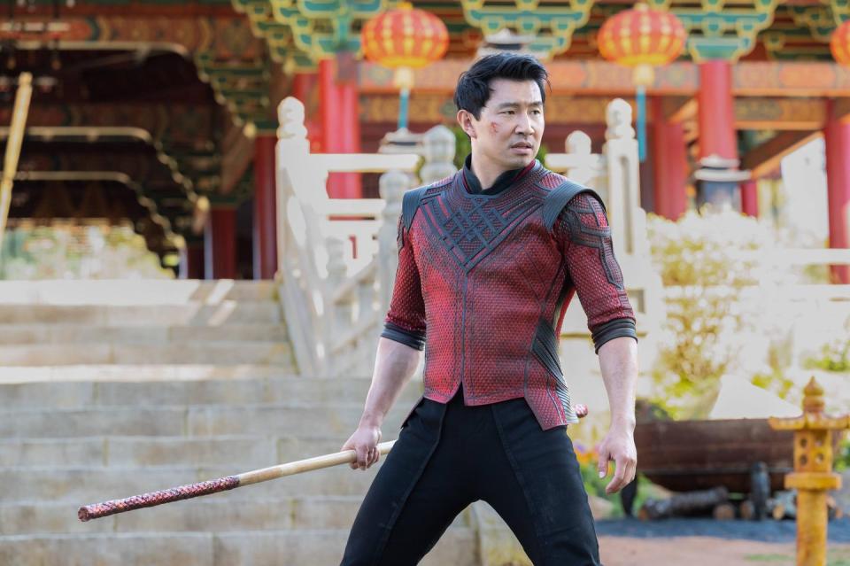 shang chi grabs a weapon in a scene from shang chi and the legend of the ten rings, the 25th movie if you want to watch all the marvel movies in order