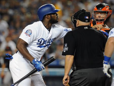 August 14, 2018; Los Angeles, CA, USA; Los Angeles Dodgers right fielder Yasiel Puig (66) pushes San Francisco Giants catcher Nick Hundley (5) after both exchange words with one another during the seventh inning at Dodger Stadium. Gary A. Vasquez-USA TODAY Sports