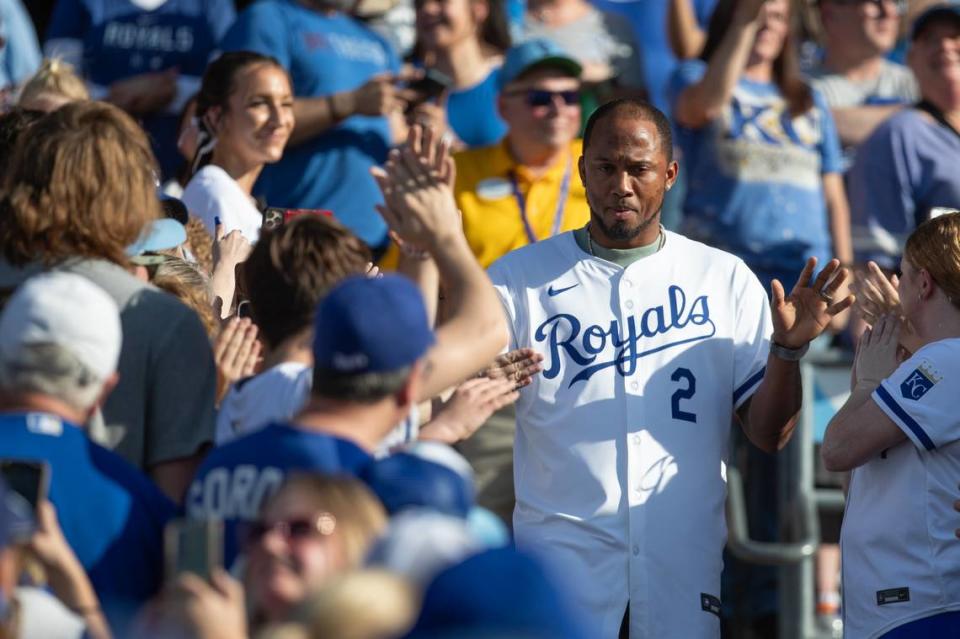 Former Kansas City Royals shortstop Alcides Escobar high-fives fans as he walks onto the field for a pre-game ceremony honoring the club’s 2014 American League champions at Kauffman Stadium on Friday, May 17, 2024.