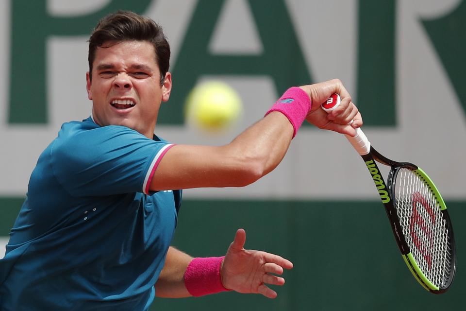 Canada's Milos Raonic plays a shot against Spain's Pablo Carreno Busta during their fourth round match of the French Open tennis tournament at the Roland Garros stadium