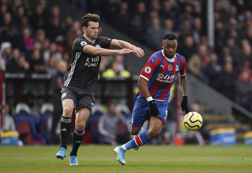 Leicester City's Ben Chilwell, left, and Crystal Palace's Jordan Ayew battle for the ball during the English Premier League soccer match at Selhurst Park, London, Sunday Nov. 3, 2019. (John Walton/PA via AP)