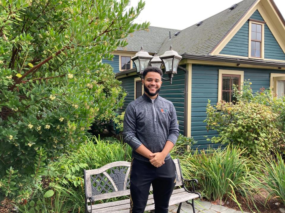 Miles Rowe Pendleton, who grew up in Eugene and recently graduated from the University of Miami, began his new role Sept. 1. He stood for a photo in front of the historic Mims House.