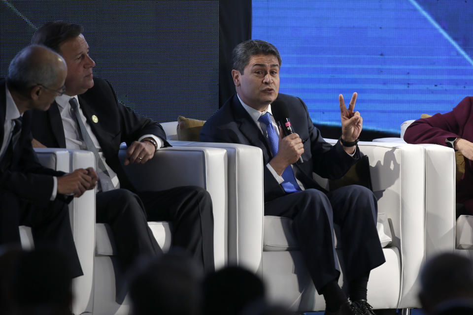 Honduras' President Juan Orlando Hernandez talks during an economic forum as part the XXVI Iberoamerican Summit in Antigua, Guatemala, Thursday, Nov. 15, 2018. The event is a biennial two-day meeting of heads of state from Latin America and the Iberian Peninsula. (AP Photo/Moises Castillo)