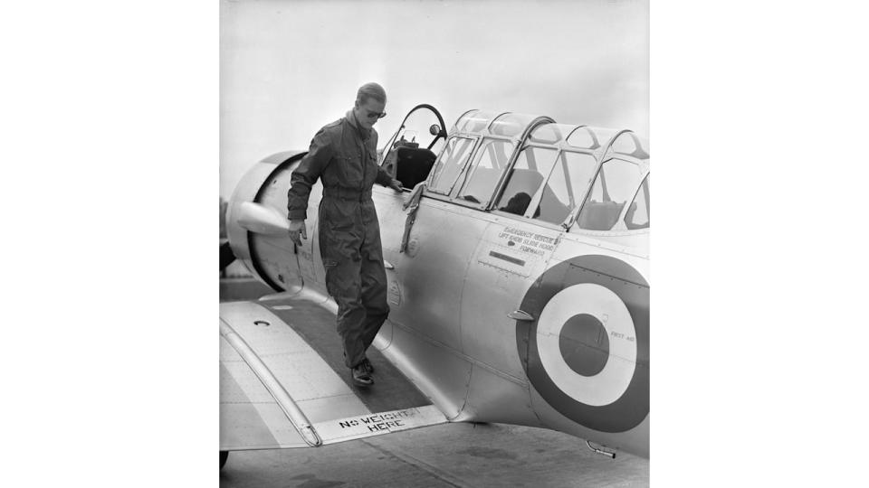 The Duke of Edinburgh disembarks from a North American Harvard Trainer aircraft after a flight, at RAF White Waltham, Berkshire, where he has been training for his 'wings'