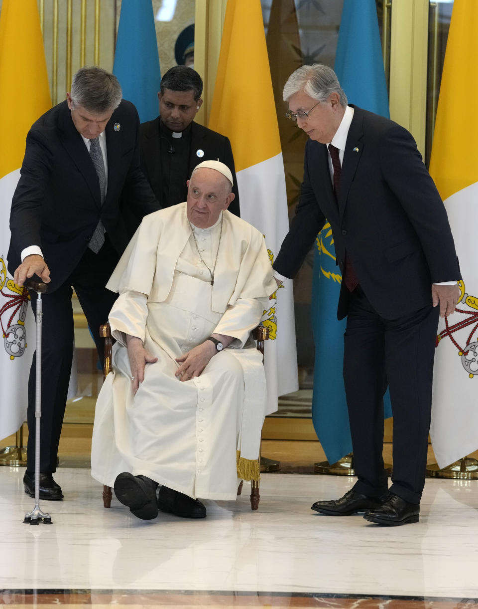 Pope Francis, left, meets the Kazakhstan's President Kassym-Jomart Tokayev as he arrives at Our-Sultan's International airport in Nur-Sultan, Kazakhstan, Tuesday, Sept. 13, 2022. Pope Francis begins a 3-days visit to the majority-Muslim former Soviet republic to minister to its tiny Catholic community and participate in a Kazakh-sponsored conference of world religious leaders. (AP Photo/Andrew Medichini)