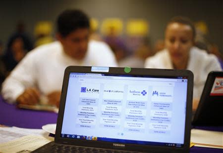 People sign up for health insurance at an enrollment event in Cudahy, California March 27, 2014. REUTERS/Lucy Nicholson