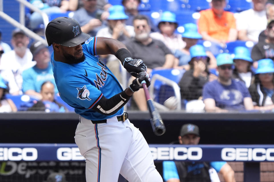 Miami Marlins' Bryan De La Cruz hits a home run during the second inning of a baseball game against the Atlanta Braves, Sunday, April 14, 2024, in Miami. (AP Photo/Wilfredo Lee)