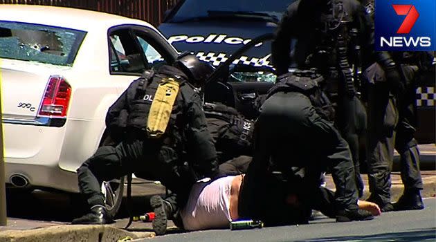 Riot police tackle a man who forced NSW state parliament into lockdown. Photo: 7News