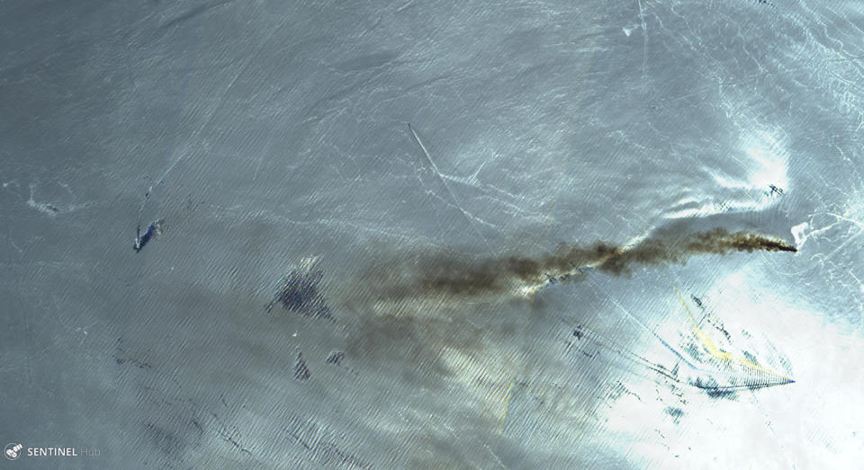 This June 13, 2019 false-color image from the European Commission's Sentinel-2 satellite that was processed by Sinergise's Sentinel Hub website shows the Norwegian-owned MT Front Altair ablaze with smoke rising from it in the Gulf of Oman after what the U.S. described as a limpet mine attack by Iran. Iran has denied being involved in the incident. The white light in the image is the sun being reflected off the waters of the Gulf of Oman. (European Commission via AP)