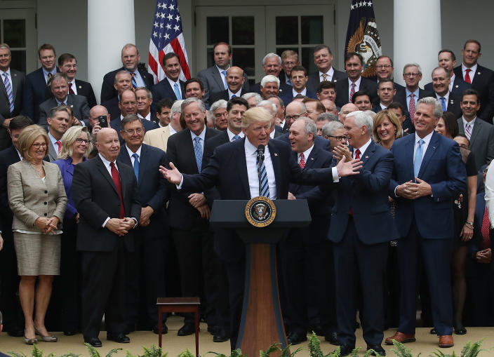 President Trump at podium flanked by House Republicans